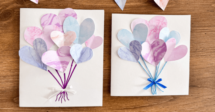 Two cards next to each other both with multiple color hearts on a white card one with purple pen drawn to each heart and the other with blue string to each heart