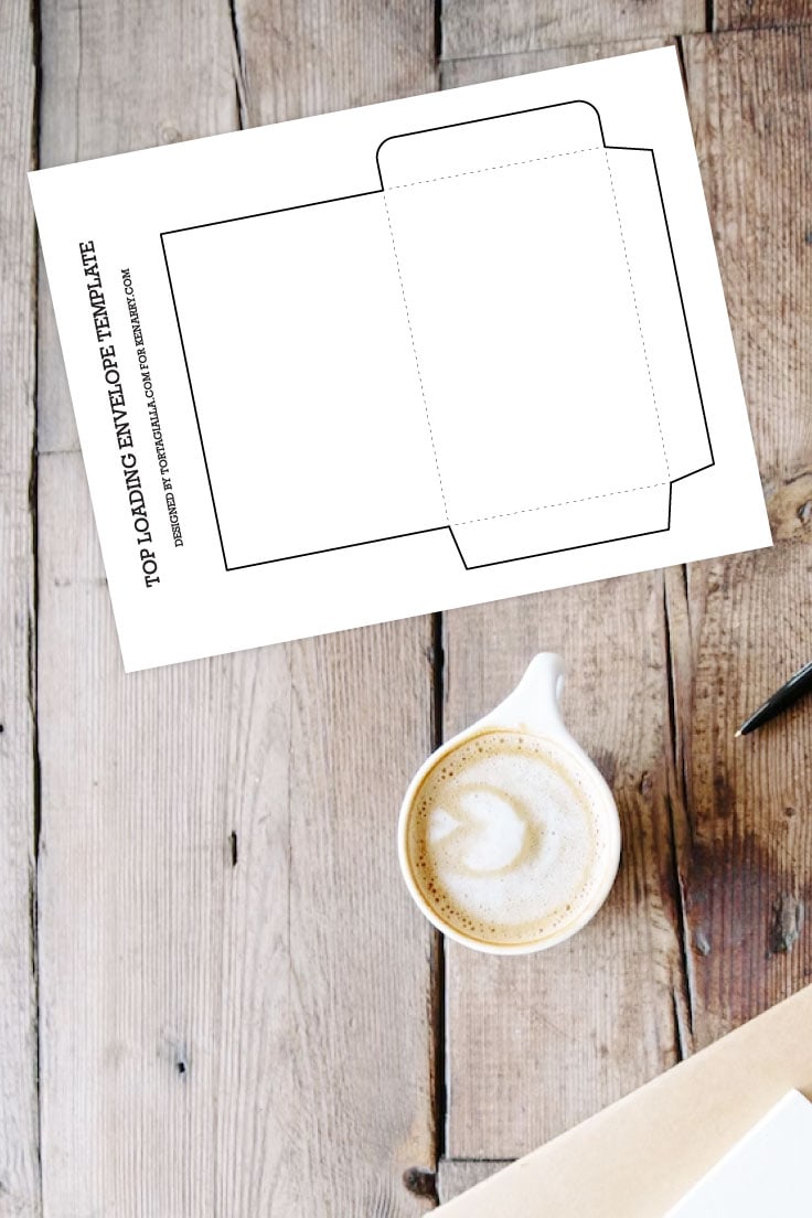 Preview of top loading envelope template page on wooden plank table background with cup of coffe, black pen and notebooks off the bottom right edge. 