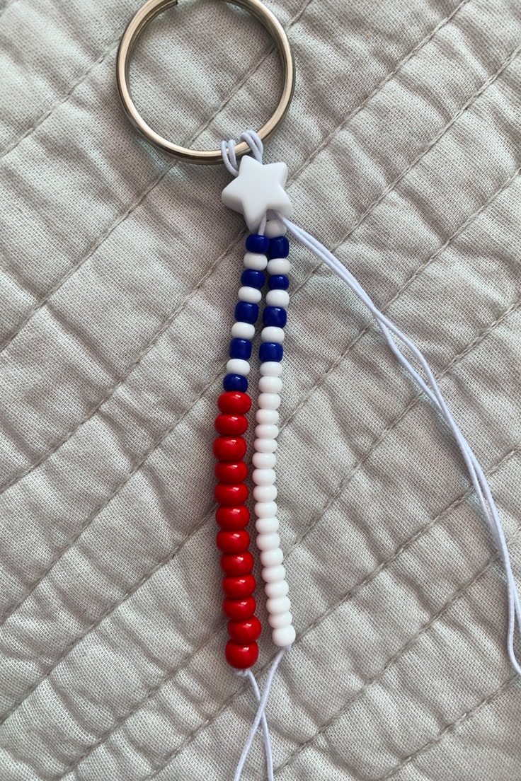 Two strands of beaded cord alternating blue and white at the top; one with red below and the other with white below.