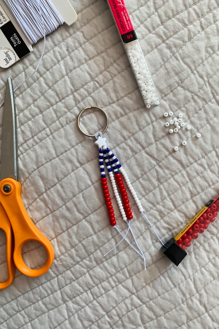 A keychain made with 4 beaded strands in red, white, and blue to resemble the American flag.