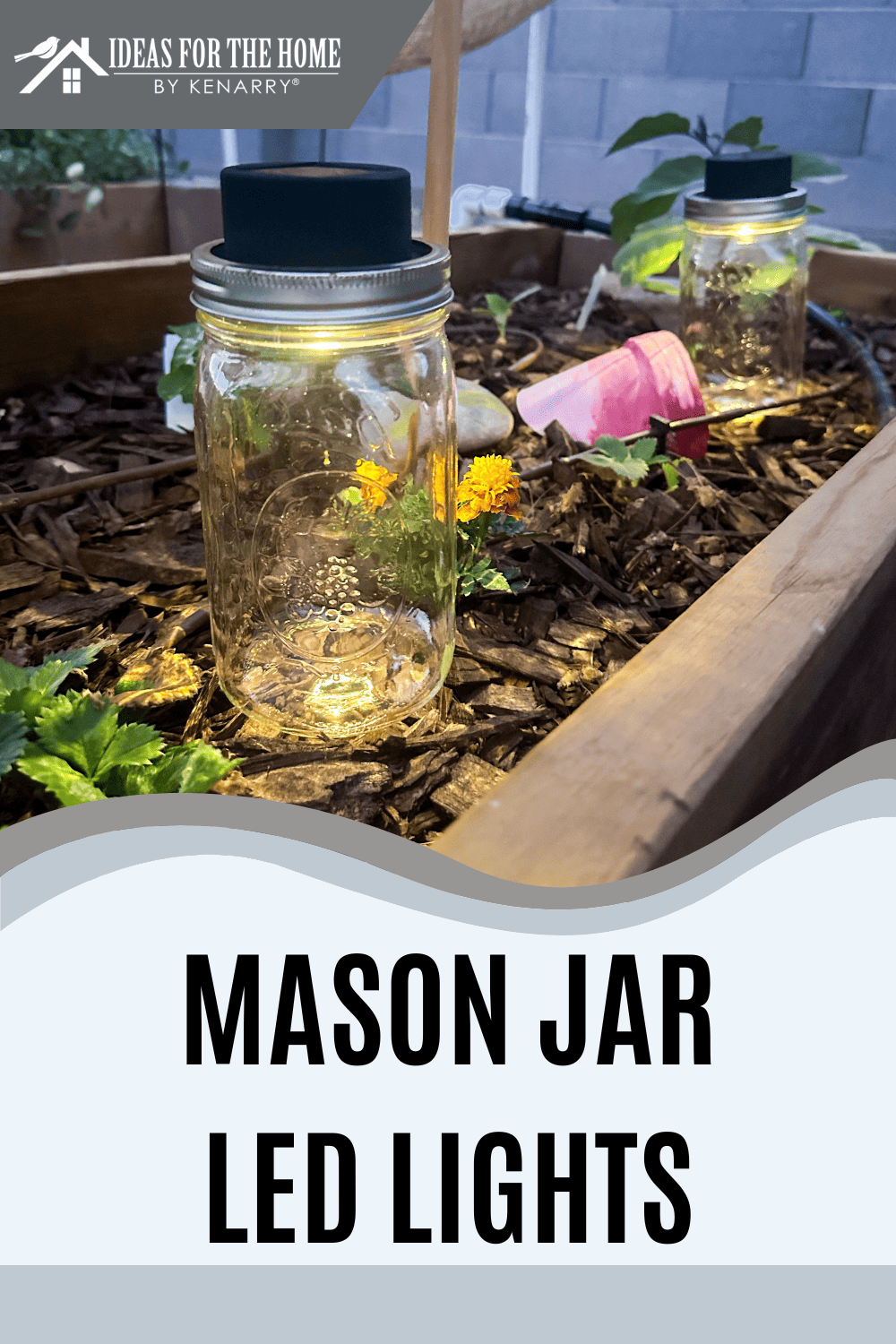 2 Mason jar lights sitting in a garden