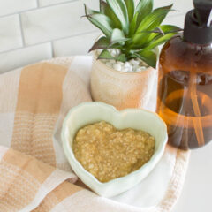 A DIY Face Mask sits in a green heart-shaped bowl, surrounded by hand soap and a small plant