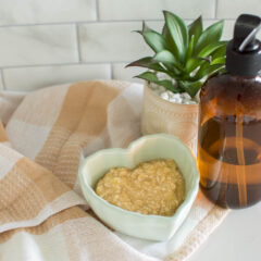 A DIY Face Mask sits in a green heart-shaped bowl, surrounded by hand soap and a small plant