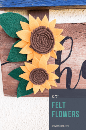 2 felt sunflowers on a wooden sign