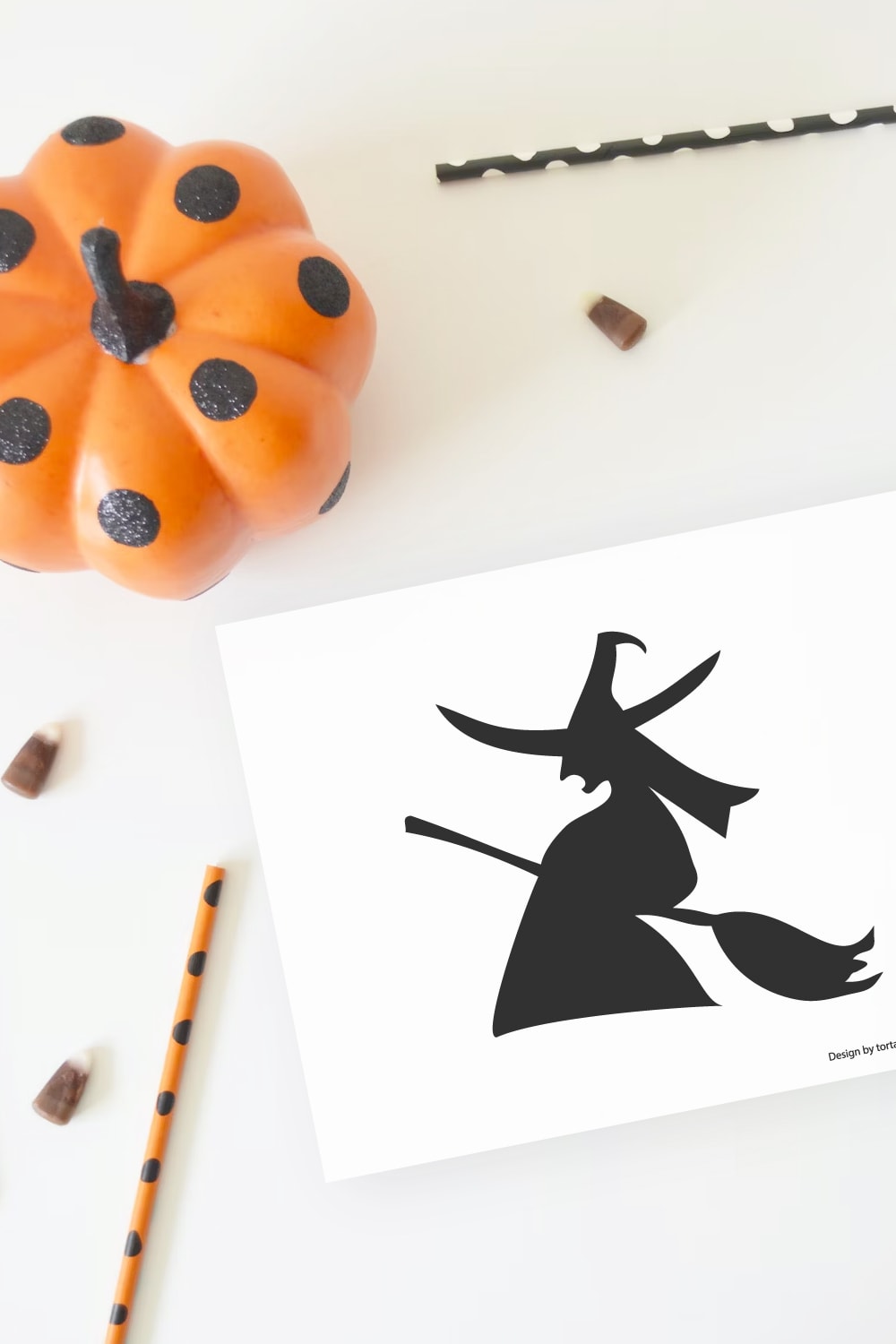 Preview of witch silhouette pumpkin stencil printable on white background with orange decorative pumpkin in upper left corner and candy corn throughout. 