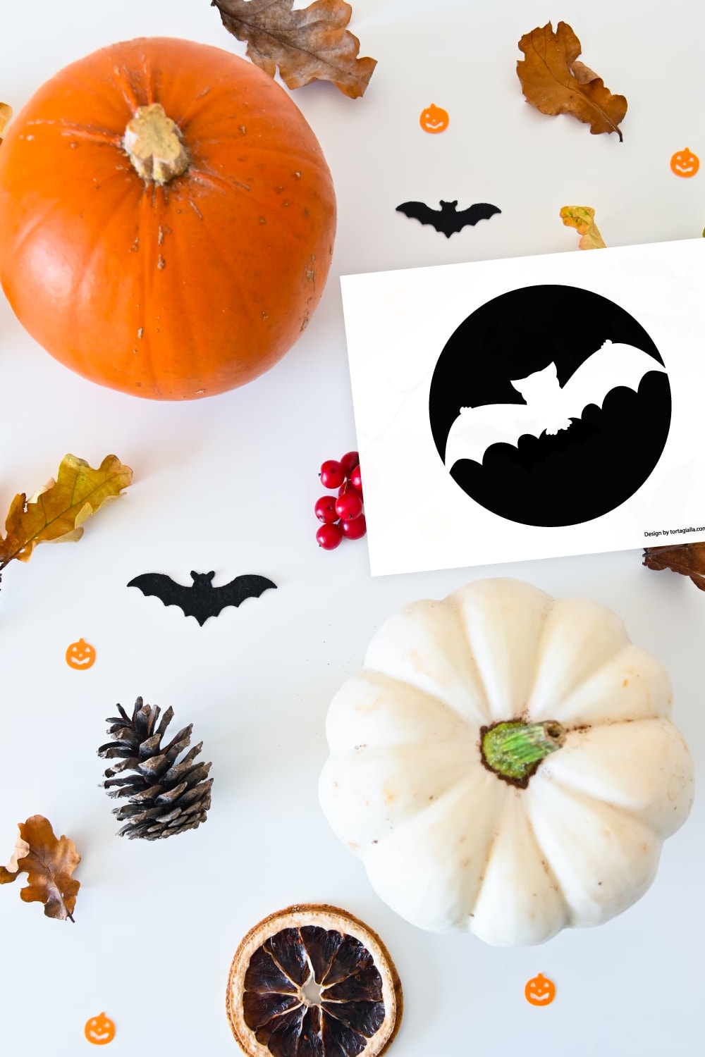 Preview of bat silhouette pumpkin stencil printable on white background with orange pumpkin in upper left corner with halloween confetti and leaves spread throughout and white pumpkin in lower right.