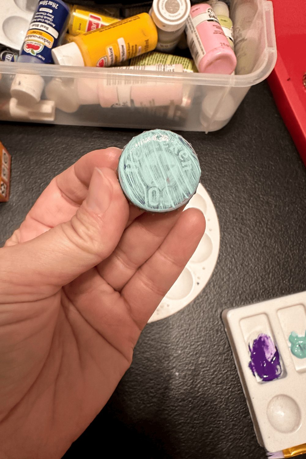 bottle cap painted blue, paint is very thin
