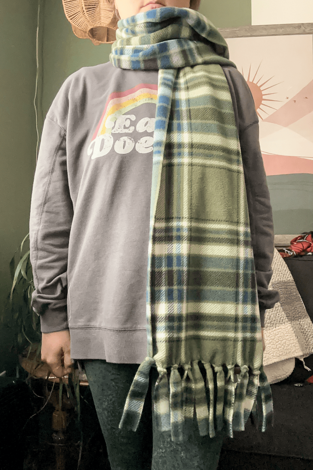 Woman wearing a green plaid scarf