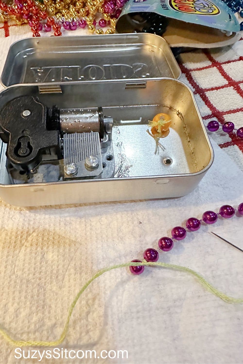 Adding bead necklaces to the music box