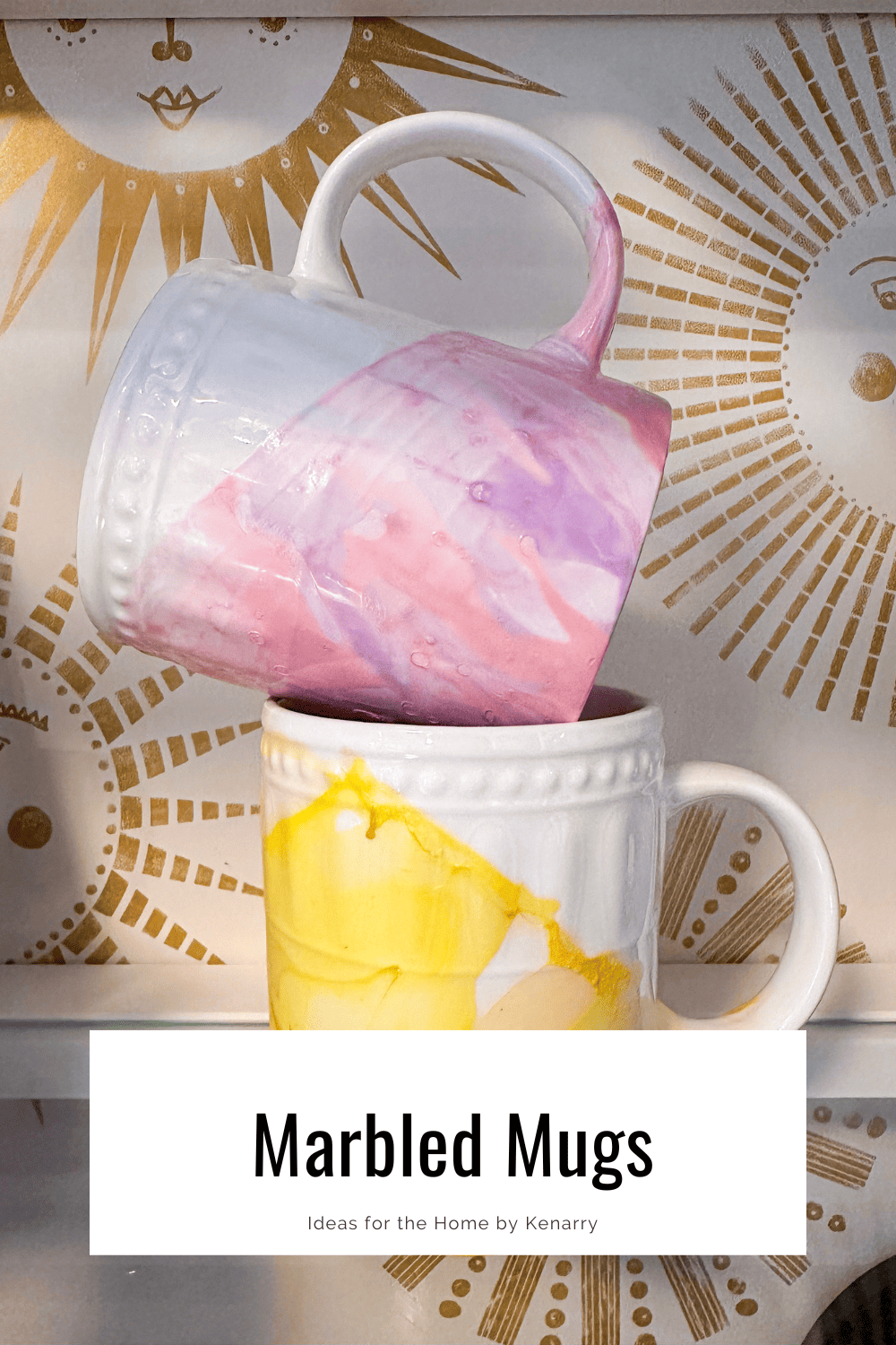 two marbled mugs stacked on top of one another