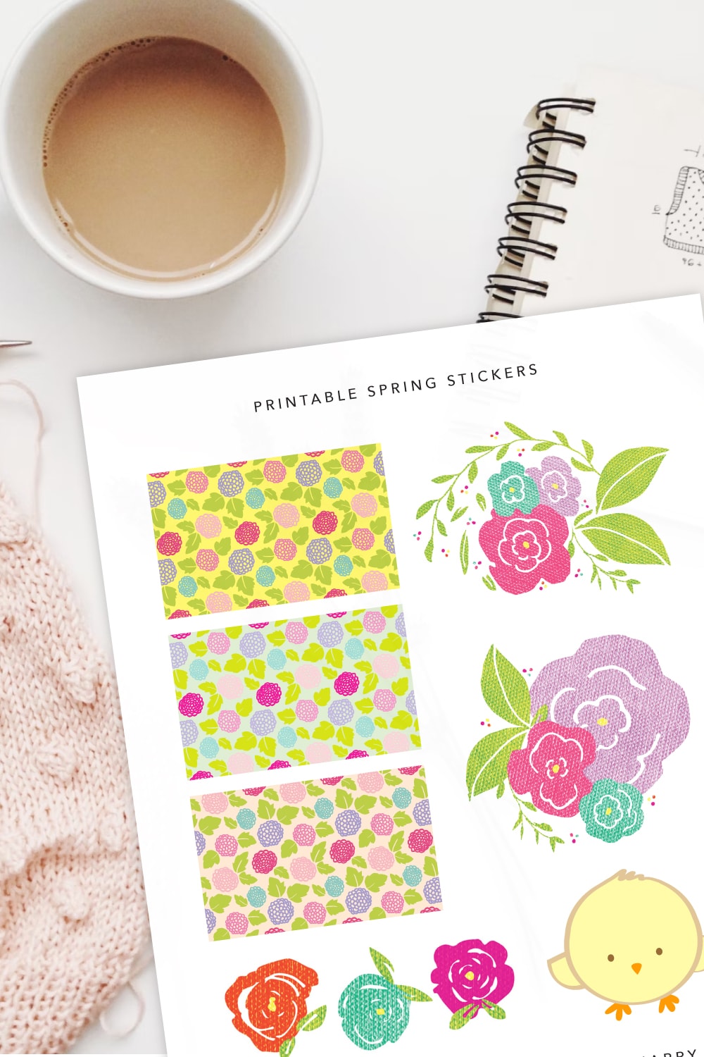 Preview of spring stickers printable page on top of a spiral notebook with cup of coffee on the upper left side and view of pink knitting on the lower left. 