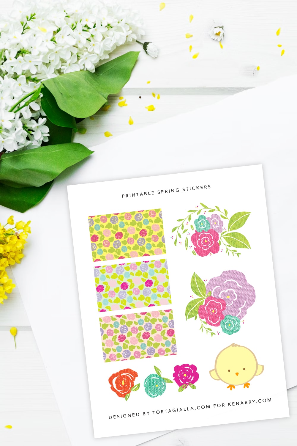 Preview of spring stickers printable page on top of a white desk with yellow and white flowers and green leaves in the upper left corner. 