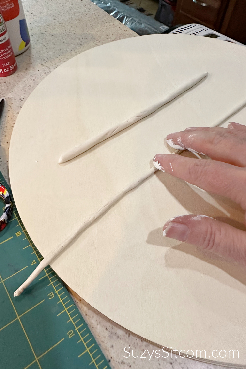 Roll out air dry clay into thin tubes.