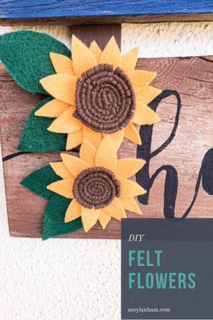 2 felt sunflowers on the edge of a sign