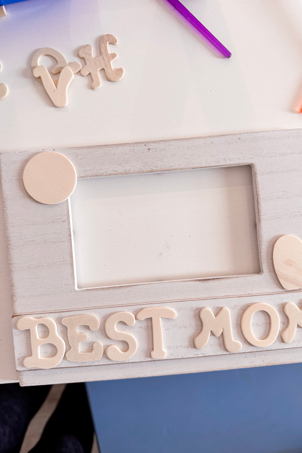 unpainted picture frame with unpainted wood letters